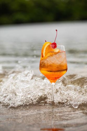 a drink with an orange slice in the water at Beach resort playa Leona in Gigantes