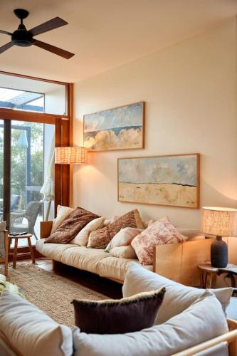 a living room with two couches and a ceiling fan at Hygge by the Ocean - Aireys Inlet in Aireys Inlet