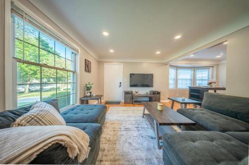 a living room with a couch and a table at Newly Renovated Townhouse on a Tranquil Street in Dearborn