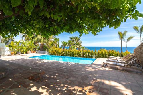 a swimming pool with a view of the ocean at Villa Lorca Vista Mar by Casasol in Nerja
