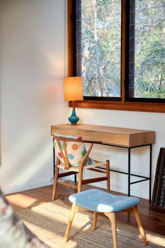 a desk with a chair and a desk with a window at Hygge by the Ocean - Aireys Inlet in Aireys Inlet
