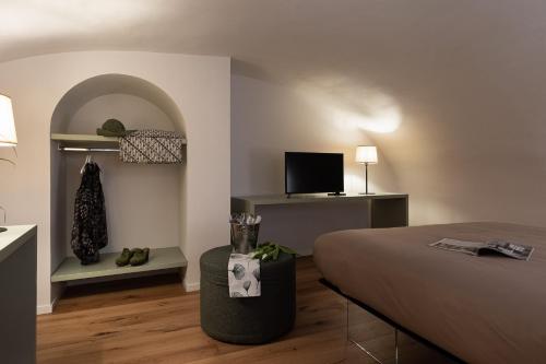 a bedroom with a bed and a tv in a room at Freshwater Pirates CASA VALENTE in Gaeta