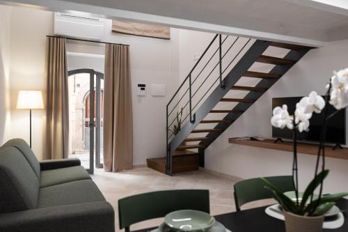 a living room with a couch and a staircase at Freshwater Pirates CASA VALENTE in Gaeta
