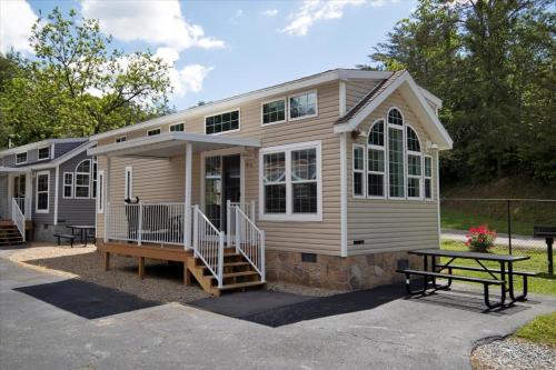 a tiny house with a picnic table in front of it at 1BR Model Home with Loft in Pigeon Forge