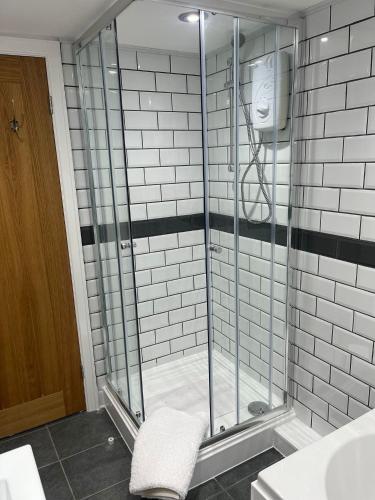 a glass shower in a bathroom with a sink at 3 Bedroom Dog Friendly Cottage with Off Lead Field in Airton