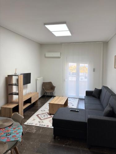 ein Wohnzimmer mit Sofa und Tisch in der Unterkunft SMYRNA HOMES KALYOPi in Chios