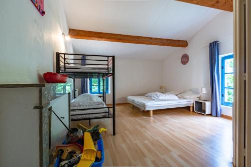 a room with a bunk bed and a bedroom at Maison de campagne au calme in Roynac