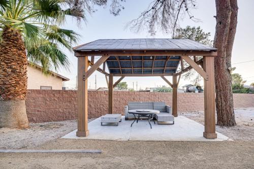 a wooden gazebo with a table and a bench and a table at 1-Acre Las Vegas Getaway Pool, Spa and Tennis Court in Las Vegas