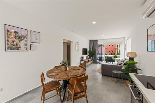 a kitchen and living room with a table and chairs at Bon Azul 5A in Westpunt