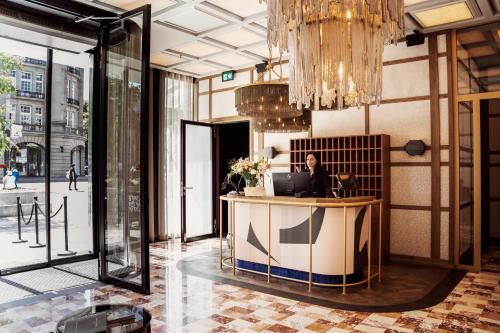a man sitting at a desk in a lobby at The Diamond Amsterdam in Amsterdam