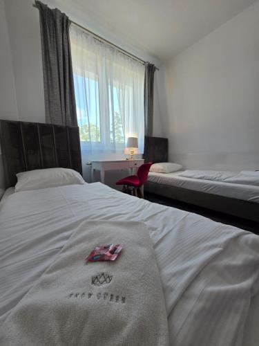 a hotel room with two beds and a window at Snow Queen in Szklarska Poręba