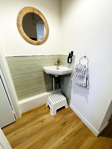 une salle de bain avec un lavabo et un miroir dans l'établissement La Demeure Bleue - Idylliq Collection, à Vénesville