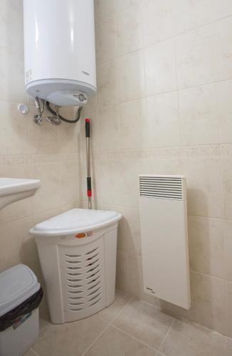 a bathroom with a toilet and a air conditioner at Mountain view apartment in Aspen Golf Resort with SPA in Bansko
