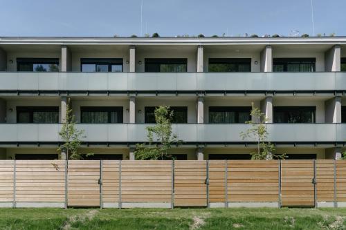 an apartment building with a fence in front of it at RELAX PARK Třeboň III in Třeboň