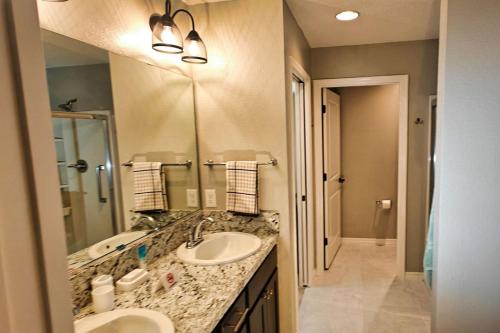a bathroom with two sinks and a large mirror at Serenity In The Villages in The Villages