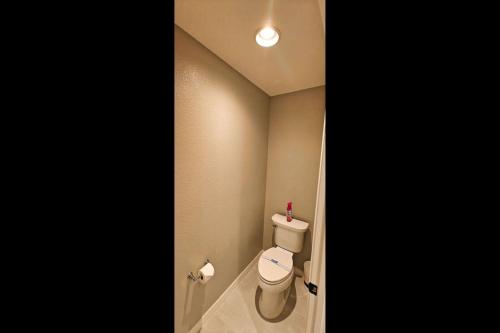 a bathroom with a white toilet in a room at Serenity In The Villages in The Villages