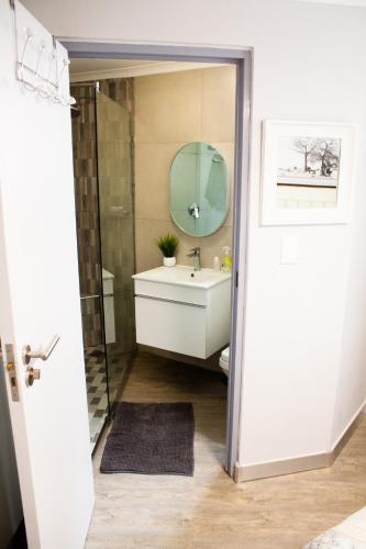 a bathroom with a sink and a mirror at SantoSea in Mossel Bay