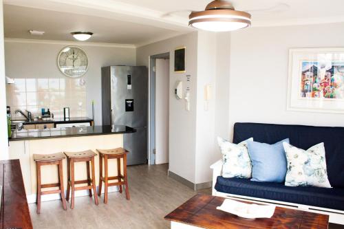a living room with a couch and a kitchen at SantoSea in Mossel Bay