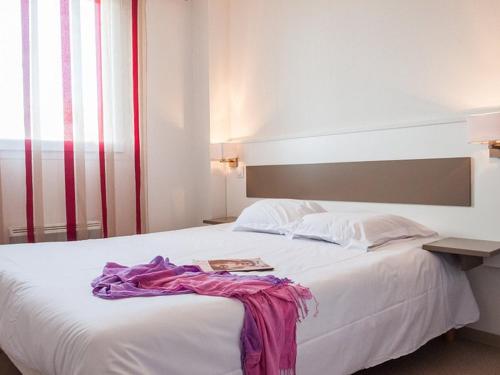 - une chambre avec un lit blanc et un livre dans l'établissement Pavillon T3 avec Piscine, Spa et Salle de Sport près de la Plage - 6 Couchages - FR-1-732-38, à Latour-Bas-Elne