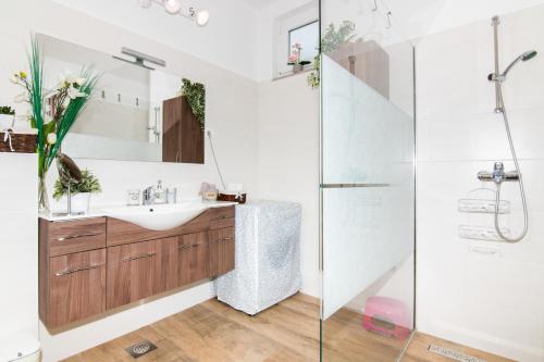 a bathroom with a sink and a shower at Cozy Istrian House in Izola
