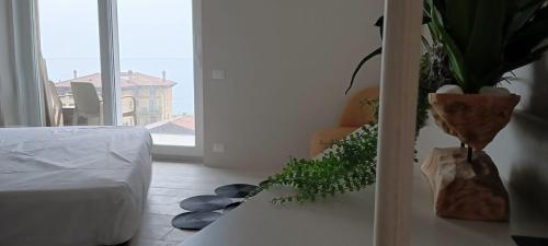 a bedroom with a table with a potted plant on it at Hotel Diana in Malcesine