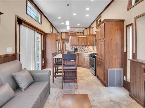 a living room with a couch and a kitchen at Lovely 1BR Cottage with Loft in Pigeon Forge