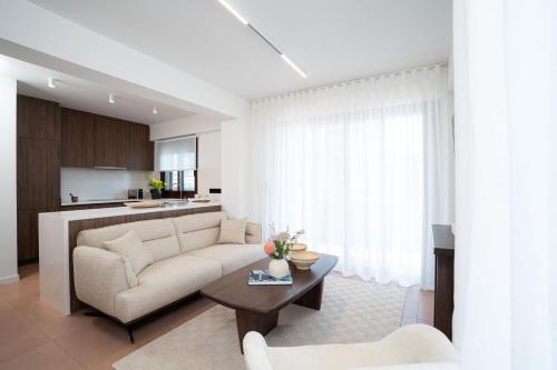 a living room with a couch and a table at Ikima Living in Piraeus