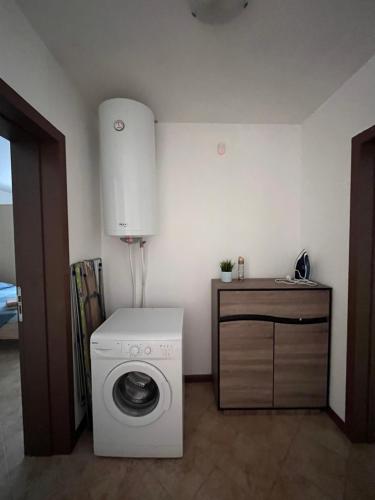 a white washing machine in a room with a counter at Oasis Resort Apartments in Lozenets