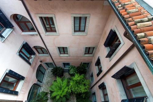 an external view of a building with plants at Mercatovecchio Luxury Suites in Udine