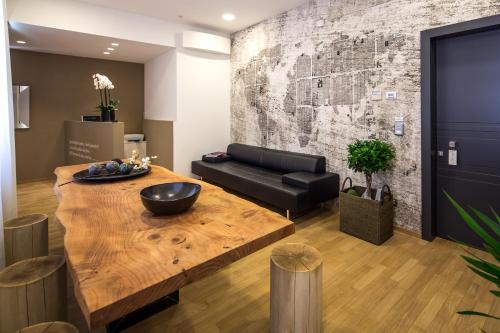 a living room with a wooden table and a couch at Mercatovecchio Luxury Suites in Udine