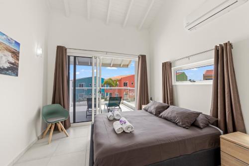 a bedroom with a bed and a large window at Punta Azul Ocean Resort 6A in Westpunt