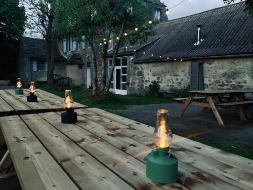 a wooden picnic table with candles on top of it at Le gîte du Brusquet in Antrenas