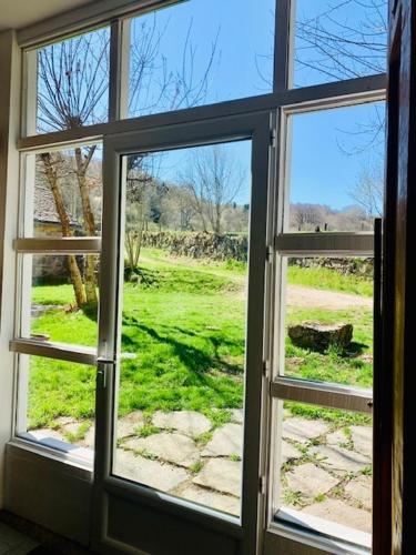 a window with a view of a field of grass at Le gîte du Brusquet in Antrenas