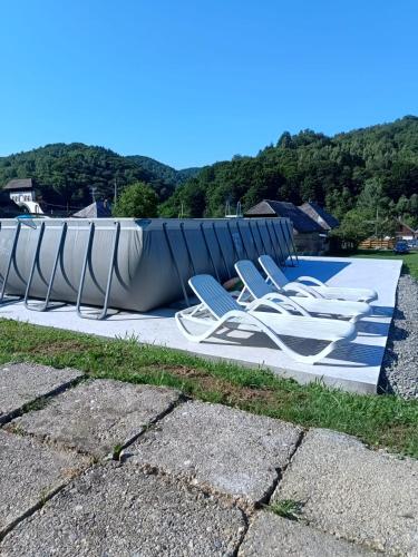 a group of lounge chairs sitting next to a pool at Casa Dyasof in Rohia