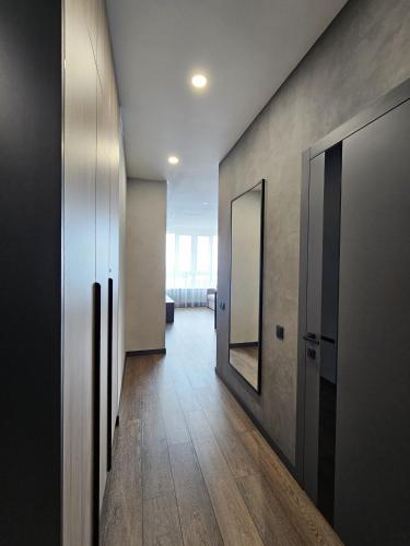 a hallway with two doors and a mirror on the wall at Apartment 98 at Park Residence in Lviv
