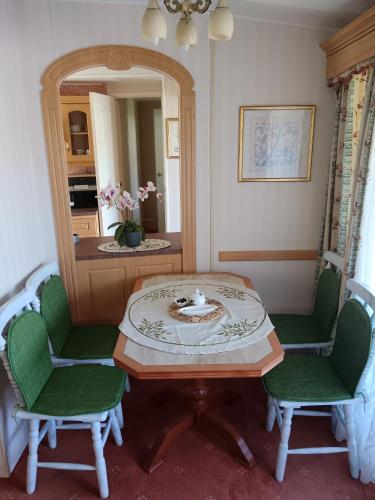 a room with a table and two chairs and a mirror at Ranch pod lesom Slovensky Raj in Spišský Štiavnik