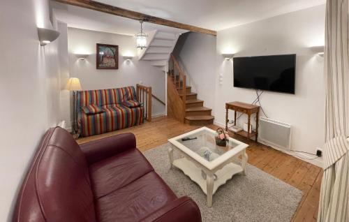 a living room with a couch and a tv at Lovely Home In Deauville With Wifi in Deauville