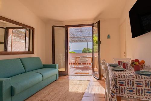 a living room with a couch and a table at Villa del sole 4 in Capoliveri