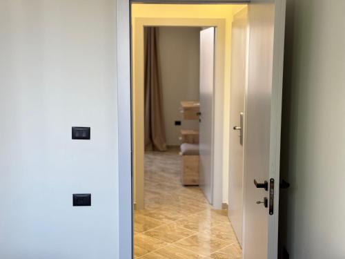 a hallway with two doors and a hallway with a room at Hotel Tuyo in Tirana