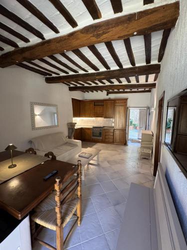 a living room with a bed and a table at La Casetta sul Porto in Porto Ercole