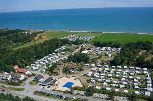 an aerial view of a parking lot next to the ocean at Svalereden Strand Camping Apartments in Frederikshavn