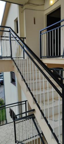 a stair case in a building with a stair railing at Sea and Sunshine in Tivat