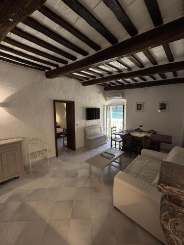 a living room with a couch and a table at La Casetta sul Porto in Porto Ercole