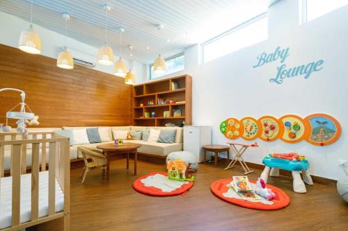 a living room with a crib and a baby nursery at Caldera Beach in Plataniás