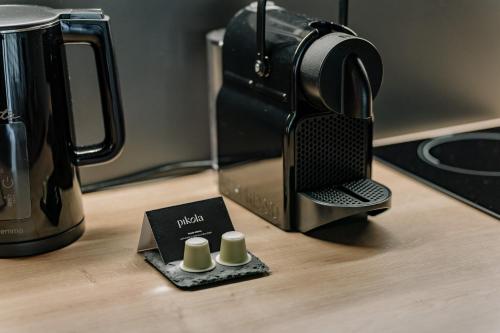 a coffee maker sitting on a table with a tea kettle at RELAX PARK Třeboň III in Třeboň