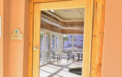 a door leading to a balcony with a table and chairs at Tilghman Resort Ocean View Paradise Aw Lazy River & Indoor Outdoor Pools in Myrtle Beach