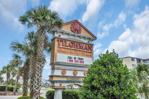 a sign for a hotel with a palm tree at Tilghman Resort Ocean View Paradise Aw Lazy River & Indoor Outdoor Pools in Myrtle Beach