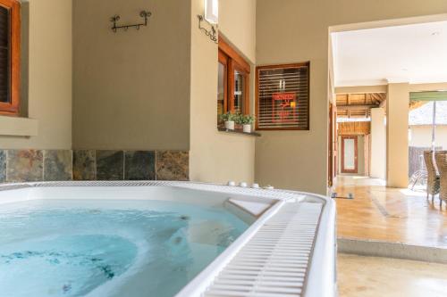 a large jacuzzi tub in a house at Zebula Golf Estate & Spa Executive Holiday Homes in Mabula