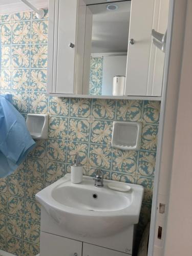 a bathroom with a sink and a mirror at SMYRNA HOMES ASTRONOMi in Chios