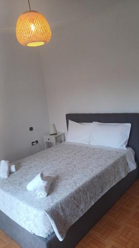 a bedroom with a large bed with a light at family home in Kanálion